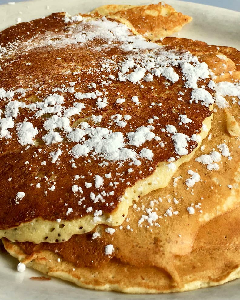 Lemon poppyseed pancakes dusted with powdered sugar